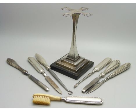 An Art Deco manicure stand, Birmingham 1935 and seven tools, six have silver handles 