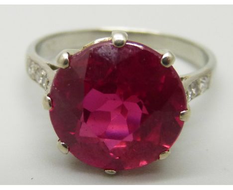 A white metal ring, set with a large synthetic ruby and diamond shoulders, 3.7g, M 