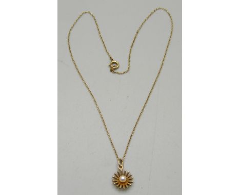 A 9ct gold pendant set with a pearl on a yellow metal chain, 2g 