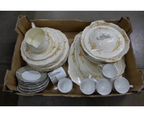 A set of six Staffordshire cups and saucers and an Alfred Meakin dinner service, three graduated platters, two vegetable dish