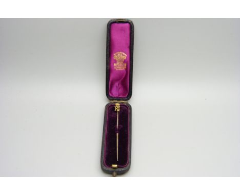 A gilt metal stick pin with crown motif, in original box 