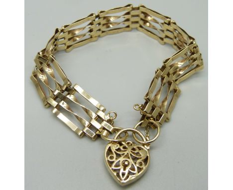 A 9ct gold gate bracelet with fretwork padlock clasp, 10.4g 