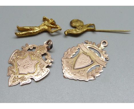 Two 9ct gold fobs, 5.3g, a miniature metal figure and a stick pin 