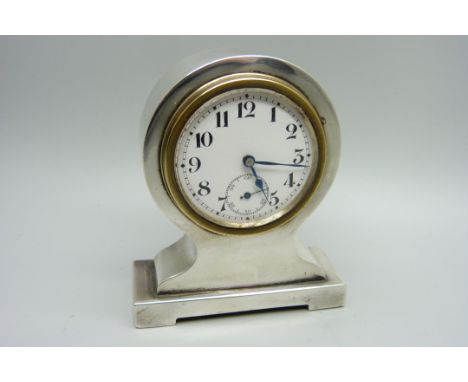 A silver desk clock, with Swiss movement 