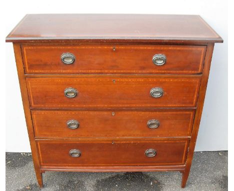 An Edwardian mahogany and cross banded chest of four graduated drawers on tapering legs and ornate brass drop handles, 109 x 