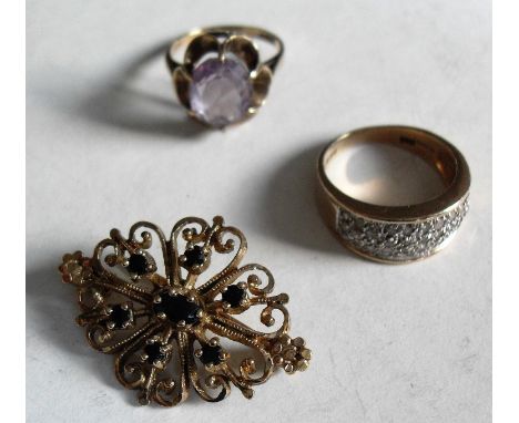 A diamond cluster ring, size L, a claw set amethyst ring, size G1/2 and a seven sapphire filigree brooch all set in 9ct gold,