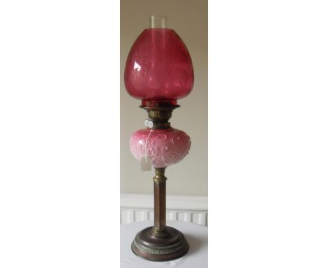 A VICTORIAN BRASS OIL LAMP with reeded pillar and foot, blancmange pink glass fount, brass duplex burner with ML trademark an