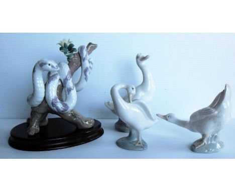 A Lladro Zodiac Collection porcelain figure modelled as a snake curled around a flowering branch (one petal missing - see mai