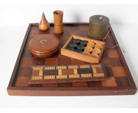 An early 20th century draughts set with board, a cribbage game, two pieces of treen, a 'Treble' brown leather-cased measuring