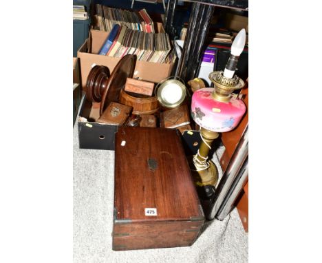 A BOX OF LOOSE SUNDRY ITEMS, to include a distressed writing slope, a brass oil lamp converted to electric, with pink glass w