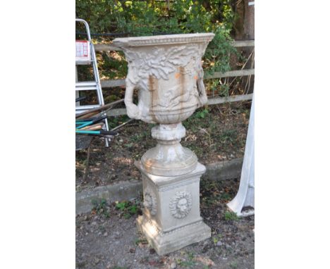 A LARGE COMPOSITE THREE PIECE GARDEN URN ON STAND, with foliate and hunting scene detail to body of the urn standing on a squ