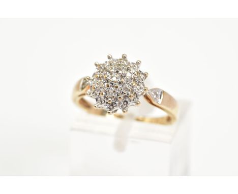 A 9CT GOLD DIAMOND CLUSTER RING, the tiered cluster set with single cut diamonds, to the diamond set tapered shoulders and pl