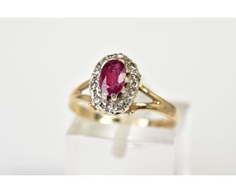 A 9CT GOLD RUBY AND DIAMOND CLUSTER RING, the tiered cluster set with a central cut ruby and single cut diamond surround, to 