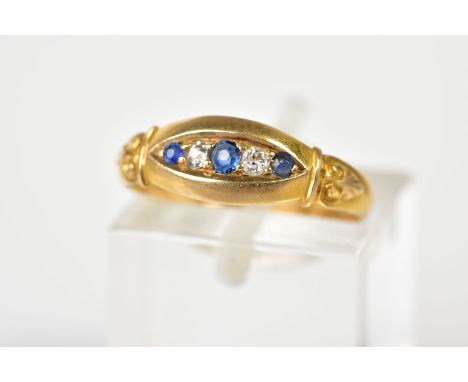 AN EARLY 20TH CENTURY 18CT GOLD BOAT RING, the central panel set with three graduated circular cut sapphires interspaced with