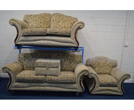 A CREAM AND FLORAL UPHOLSTERED FOUR PIECE LOUNGE SUITE, comprising a three and a two seater settee, armchair and a pouffe (sd
