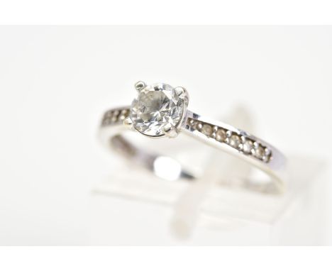 A SINGLE STONE RING, the white metal ring set with a central circular cut stone assessed as paste, to the colourless stone se