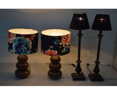 A PAIR OF MODERN BROWN CERAMIC TRIPLE BOBBIN TABLE LAMPS with floral shades, together with another pair of decorative table l