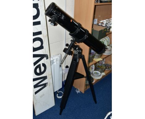 A SIMMONS ASTRONOMICAL TELESCOPE MODEL 6450, focal length 900mm, diameter 4.5 inches, together with a tripod