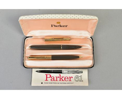 A CASED PARKER 61 ROLLED GOLD FOUNTAIN PEN SET, both marked 1/10'' 14ct gold with dark grey barrels, fountain pen is missing 