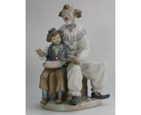 Nao large figure group of seated clown with clown boy playing accordion, height 31cm  (one finger broken & present)