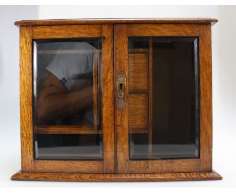 Edwardian oak 2 door smokers cabinet, bevelled glass doors , fitted with pipe rack and drawers, height 31cm x 39cm