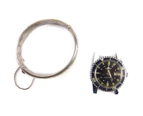 A silver hinged bangle, with half hoop decoration and a Salvest wristwatch head. (2,AF)