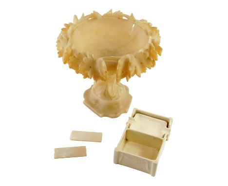 A Continental carved alabaster centrepiece, decorated with leaves, two engraved mother of pearl gaming counters, and an Empir