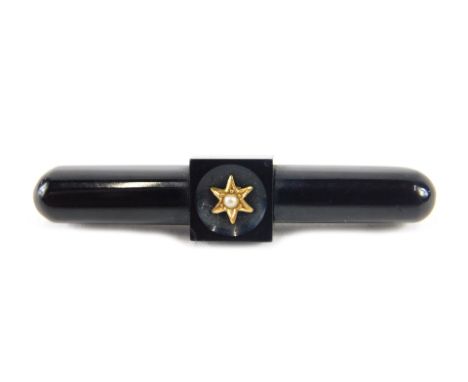A Victorian bar brooch, the bar set with black jet and with star and seed pearl centre, on plated back, 4.5cm wide, 4g all in