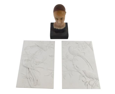 Two resin plaques of birds, 24cm x 16cm, and a carved and painted wooden mannequin bust, 19cm high. (3) 