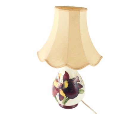 A Moorcroft baluster shaped ceramic table lamp, decorated with a band of flowers, on a cream ground, with tapering shade, 50c