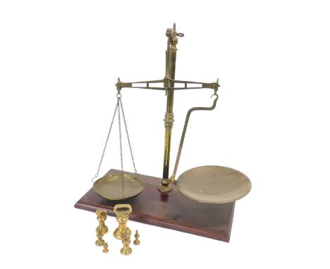 A set of brass and mahogany scales, with turned beam and some weights, 44cm wide.