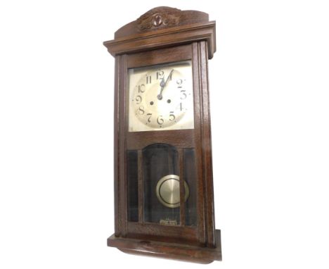 A 1920s oak mantel clock, the silvered dial with Arabic numbers, 74cm high.