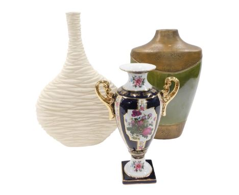 A continental porcelain two handled vase, with printed decoration of flowers, on a blue ground with gilt handles, 35cm high, 