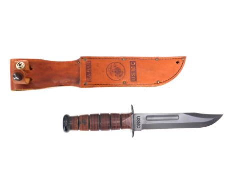 A replica hunting knife stamped USMC, the scabbard also stamped KA-BAR, 34cm long.