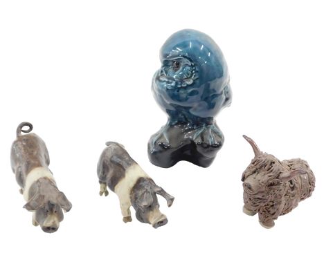 A Poole Pottery owl, two Studio Pottery pigs, and a similar highland cow. (4)