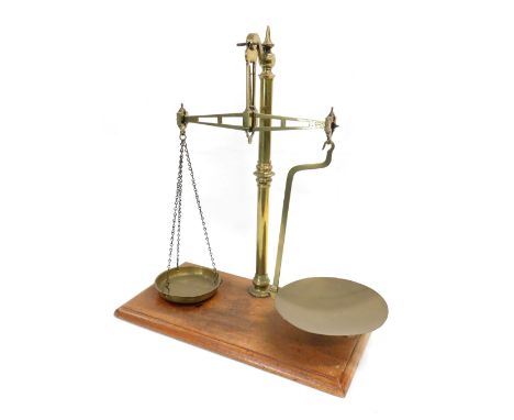 A set of brass and mahogany scales, with turned beam, 50cm wide. 