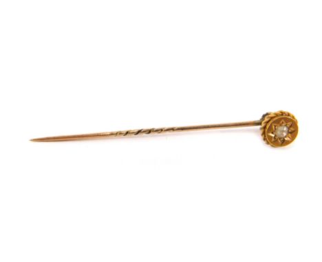 A stick pin, the top set with tiny diamond in star setting, on a gold rope twist head, yellow metal, unmarked, 5.5cm high, 1.
