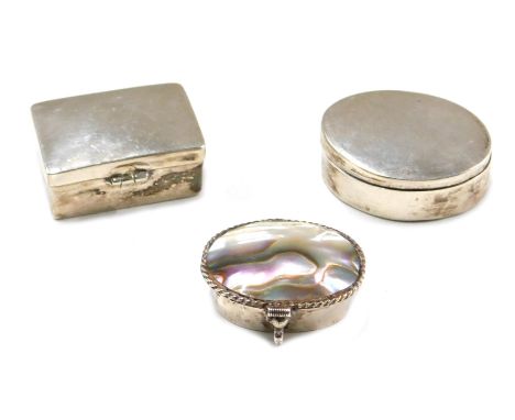 Three Continental white metal pill boxes, one mother of pearl set, the other oval, another rectangular, each white metal, som