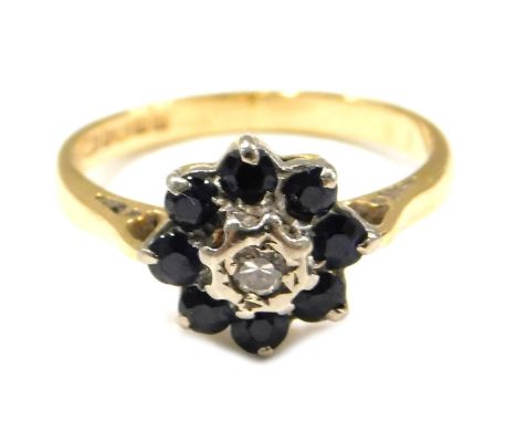 An 18ct gold sapphire and diamond cluster ring, set with central diamond, surrounded by eight sapphires, each claw set, ring 