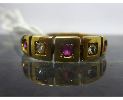 An antique 15ct yellow gold, ruby and diamond ring set with three rubies and two diamonds in squared settings, 2.1g, Ring siz