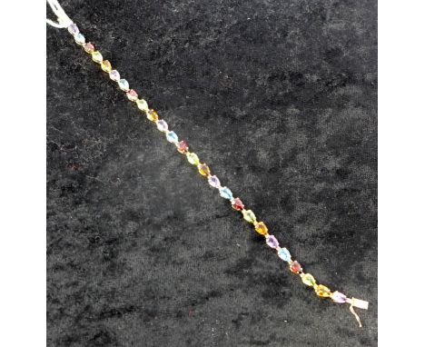 A 9ct yellow gold and mutli-gem tennis bracelet, alternately set with tear-drop shaped faceted amethyst, blue topaz, garnet, 
