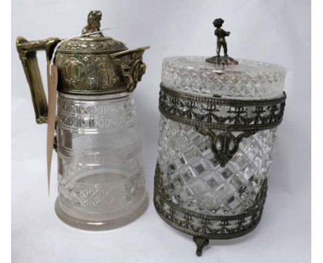 A cut glass claret jug, having silver plated cover with lion finial and a cut glass barrel with silver plate putti finial to 