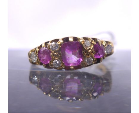 A Victorian 18ct yellow gold graduated ruby and diamond ring set with three rubies and six small diamonds, 3.8g, Ring size: O