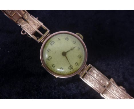 A ladies vintage 9ct rose gold watch, having engraved design to bracelet, the dial Arabic numerals. Gross weight 29.7g 