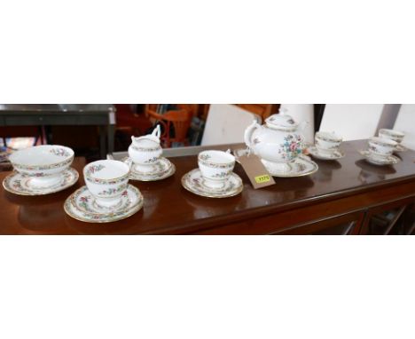 A Coalport china teaset in the 'Ming Rose' pattern, consisting of teapot, sugar bowl, milk jug, platter, 5 cups, saucers and 