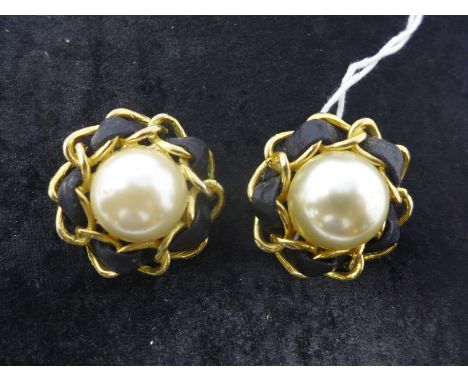 A pair of vintage Chanel classic clip-on earrings, circa 1960's, composed of a central faux pearl and framed by a gilt metal 
