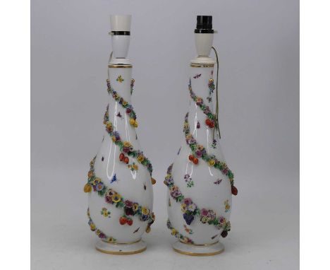 A pair of early 20th century Dresden porcelain vases, each of teardrop shape with applied floral decoration having underglaze