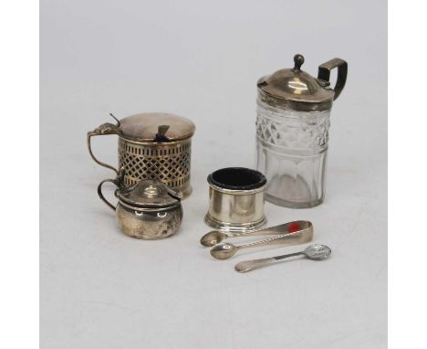 A Victorian silver mustard, of pierced cylindrical form, having hinged lid with thumbpiece and blue glass liner, with an asso