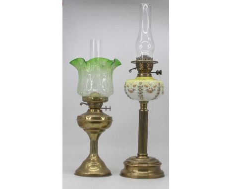 A Victorian oil lamp, having a yellow glass font on a brass fluted column and circular base, h.70cm (including chimney); toge