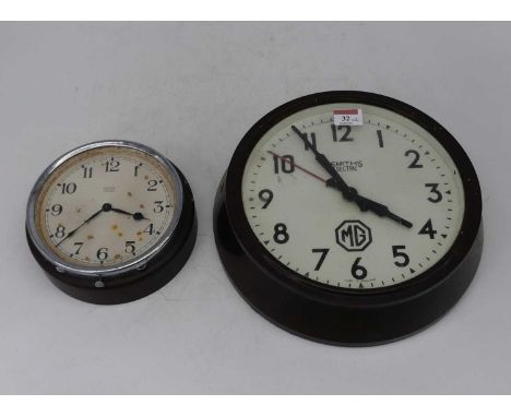 A mid-20th century Smiths Sectric wall clock, the circular dial with Arabic numerals and MG emblem, within bakelite surround,